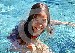 Little girl green eyes children playing at pool at tropical resort in Los Cabos Mexico