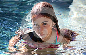 Little girl green eyes children playing at pool at tropical resort in Los Cabos Mexico