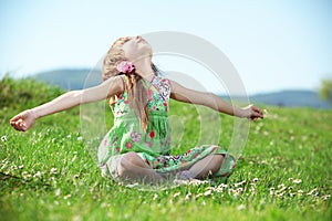 Little girl at green field