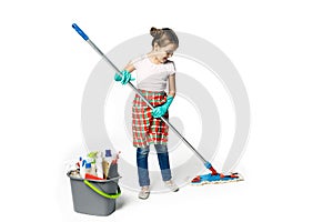 Little girl in green rubber gloves ready for cleaning. She holds a mop in her hands