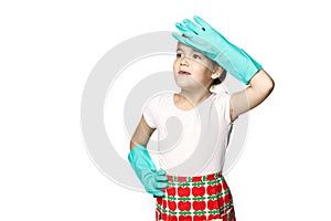 Little girl in green rubber gloves ready for cleaning. Wipes sweat from his forehead after harvesting isolated on a white