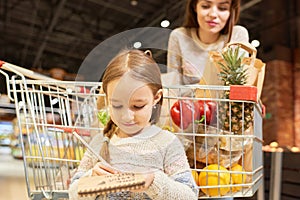 Little Girl Grocery Shopping with Mom