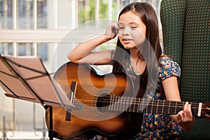 Little girl during a guitar lesson