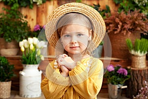 Little girl hand praying, hands folded in prayer concept for faith, spirituality and religion. Happy little blond girl in a yellow