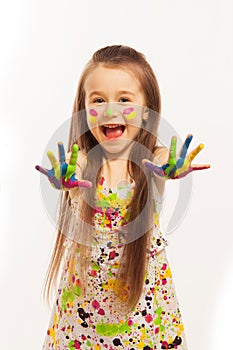 Little girl with hands painted in colorful paint