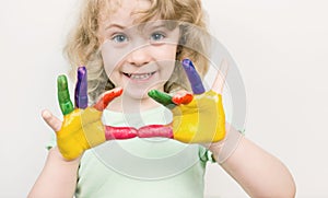 Little girl hands painted in colorful paints