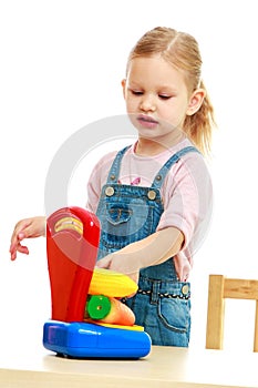 Little girl hanging in the balance fruit