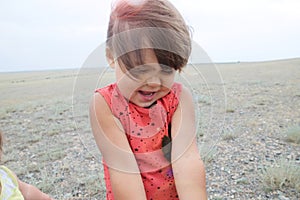 Little girl happy smiling in big landscape environment. Child emotionally with expression outdoor