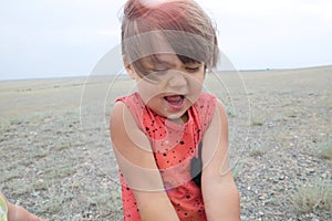 Little girl happy smiling in big landscape environment. Child emotionally with expression playing