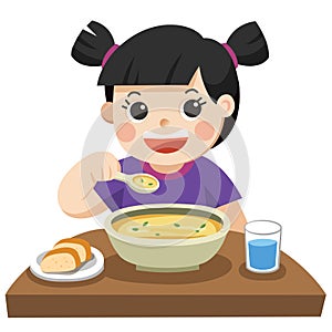 A Little girl happy to eat Soup