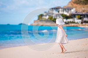 Little girl in hat at the beach during caribbean vacation