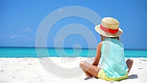 Little girl in hat at the beach during Caribbean vacation