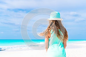 Little girl in hat at the beach during caribbean vacation