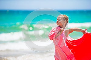 Little girl have fun with beach towel during