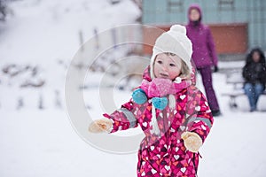 Little girl have fun at snowy winter day