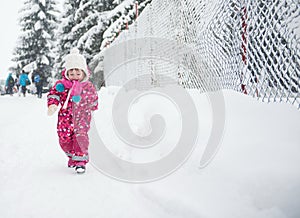 Little girl have fun at snowy winter day