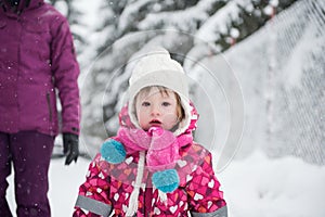 Little girl have fun at snowy winter day