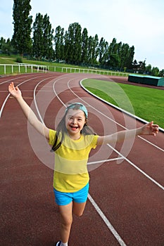 Little girl have fun on the stadium