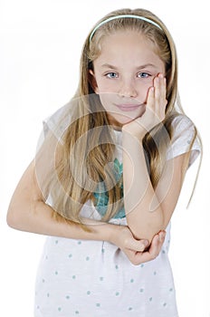 Little girl have toothache. Emotional portrait of caucasian girl wearing white t-shirt. Sad child with tooth pain. Dental problem