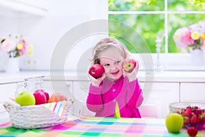 Little girl having fruit for breakfast