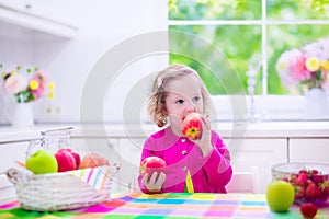 Little girl having fruit for breakfast