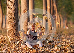Little girl having fun on beautiful autumn day