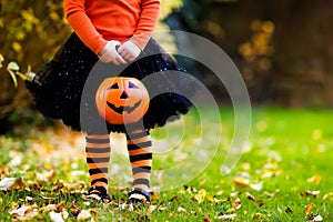 Little girl having fun on Halloween trick or treat photo