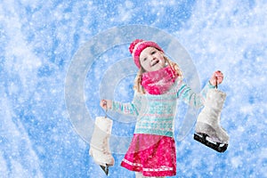 Little girl having fun at ice skating in winter