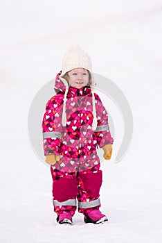 Little girl having fun at snowy winter day