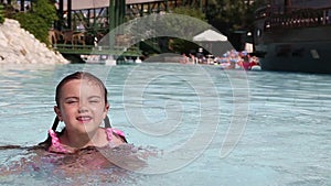 Little girl having fun in a swimming pool