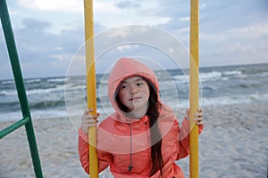 Little girl having fun on the swing