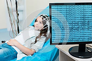 Little girl having her brain waves recorded via electroencephalograph