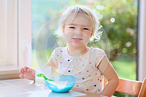 Little girl having oatmeal for breakfast