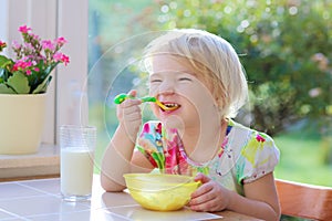 Little girl having oatmeal for breakfast