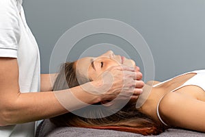 Little girl having osteopathic jaw treatment. photo