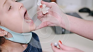 Little girl having a throat examination at pedeatrician`s office