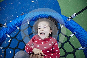 Little girl having a tickle attack at the park