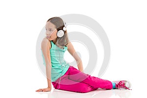 Little girl in headphones looking back