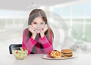 Little girl with healthy and unhealthy food