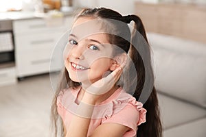 Little girl with hearing aid