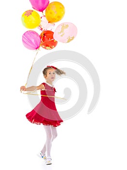 Little girl with helium balloons.