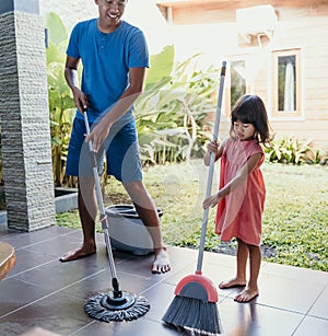 Little girl help her daddy to do chores