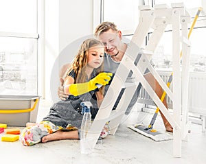 Little girl helping dad at cleaning