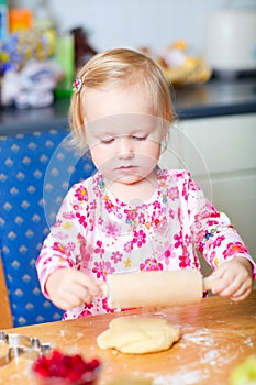 Little girl helping at kitchen