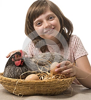 Little girl with a hen (chicken)