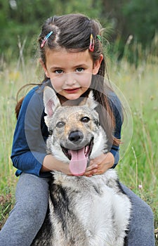 Little girl and her baby wolf dog
