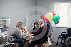 A little girl with her family in a hostipal ward after an accident