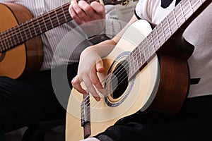 little girl and her father are playing guitar. Learning to play the guitar. Music education and extra-curricular lessons