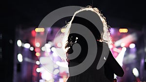 Little girl on her father`s shoulder watching and cheering in the audience