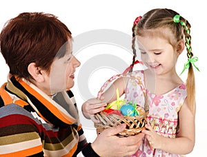 Little girl and her grandmother with basket full of easter eggs